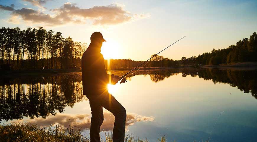 Fishing at the edge of the Chevanel pond in the evening