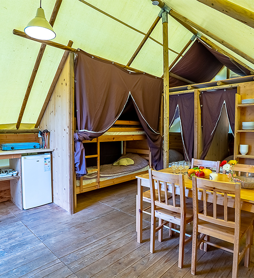 Inmitten einer grünen Naturlandschaft liegen die ungewöhnlichen Trapperzelte zur Miete für eine ungewöhnliche Unterkunft auf dem Campingplatz Les Ballastières in Burgund-Franche-Comté