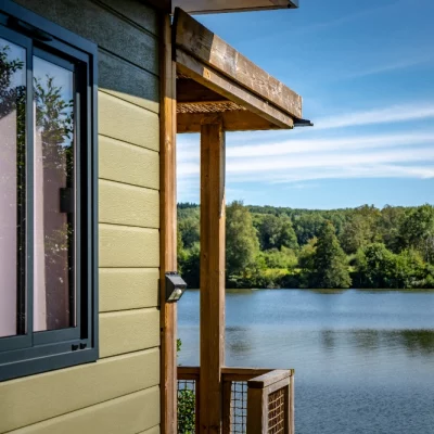 Vue sur lac depuis une terrasse en bois.