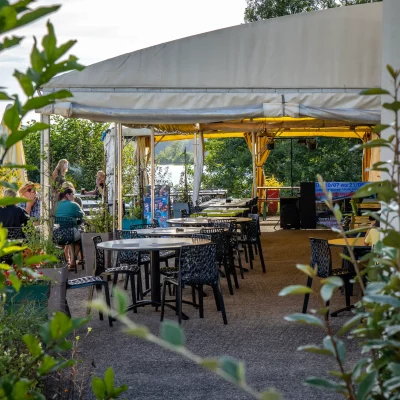Terrasse extérieure avec tables et chaises, ambiance conviviale