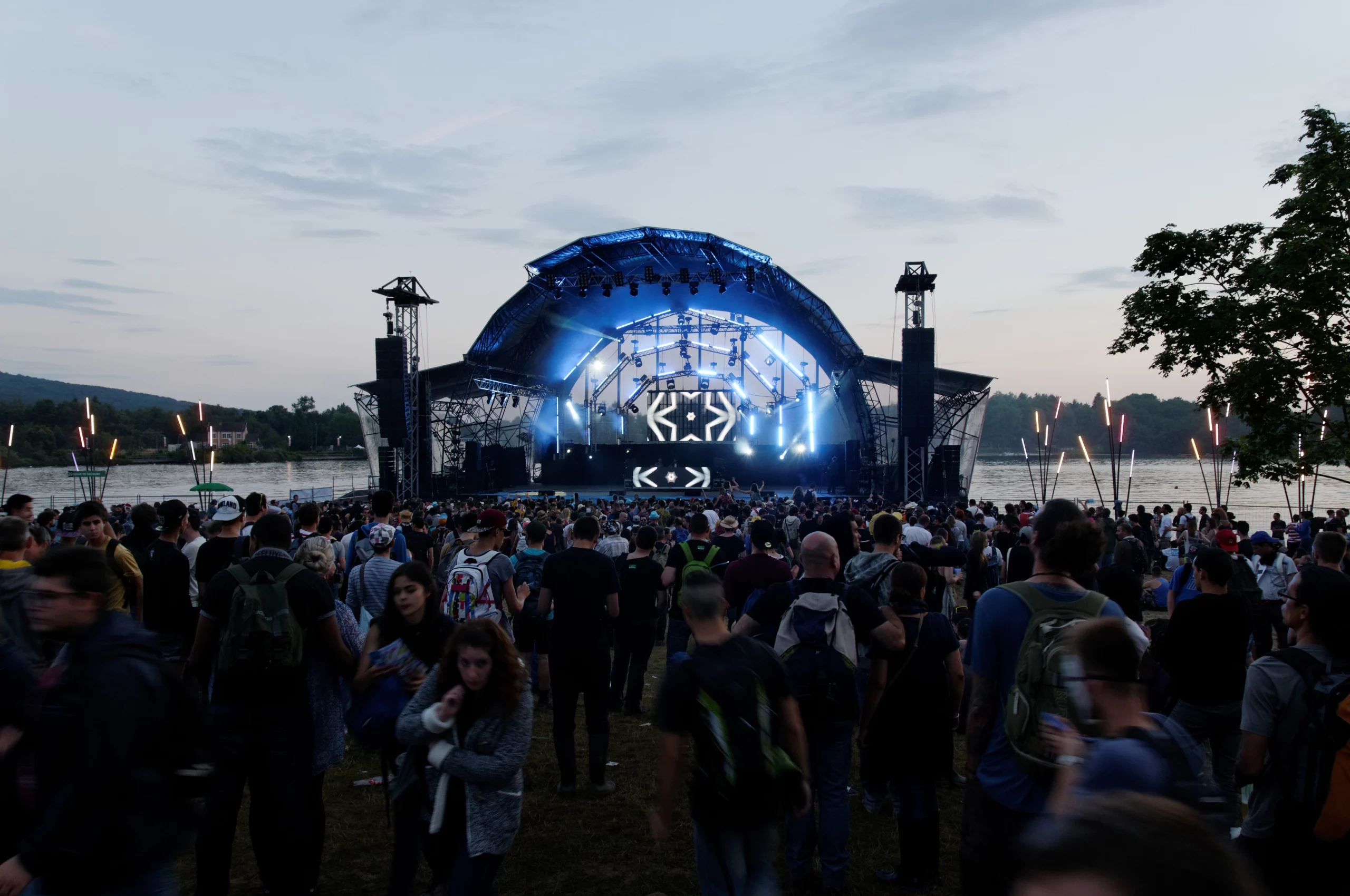 Concert en plein air avec foule enthousiaste.