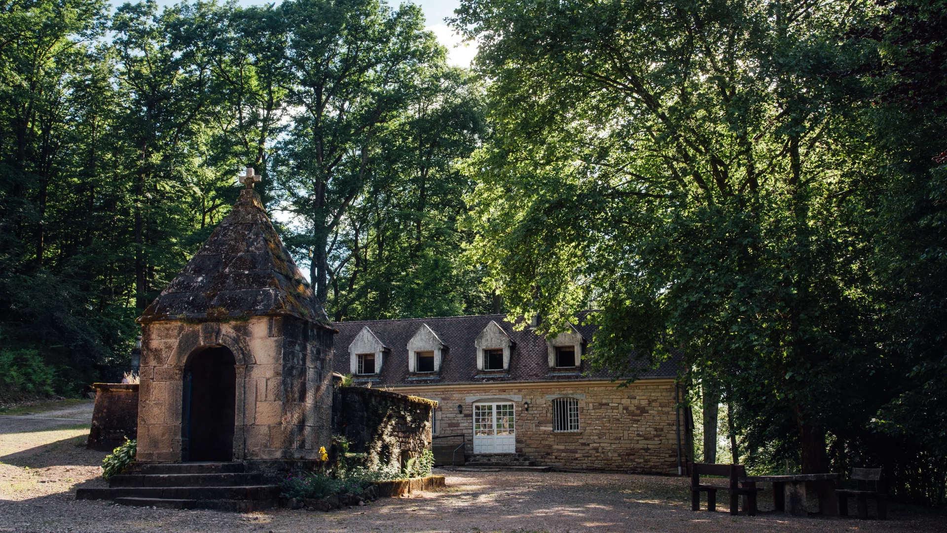 Rustic stone chapel in lush forest setting