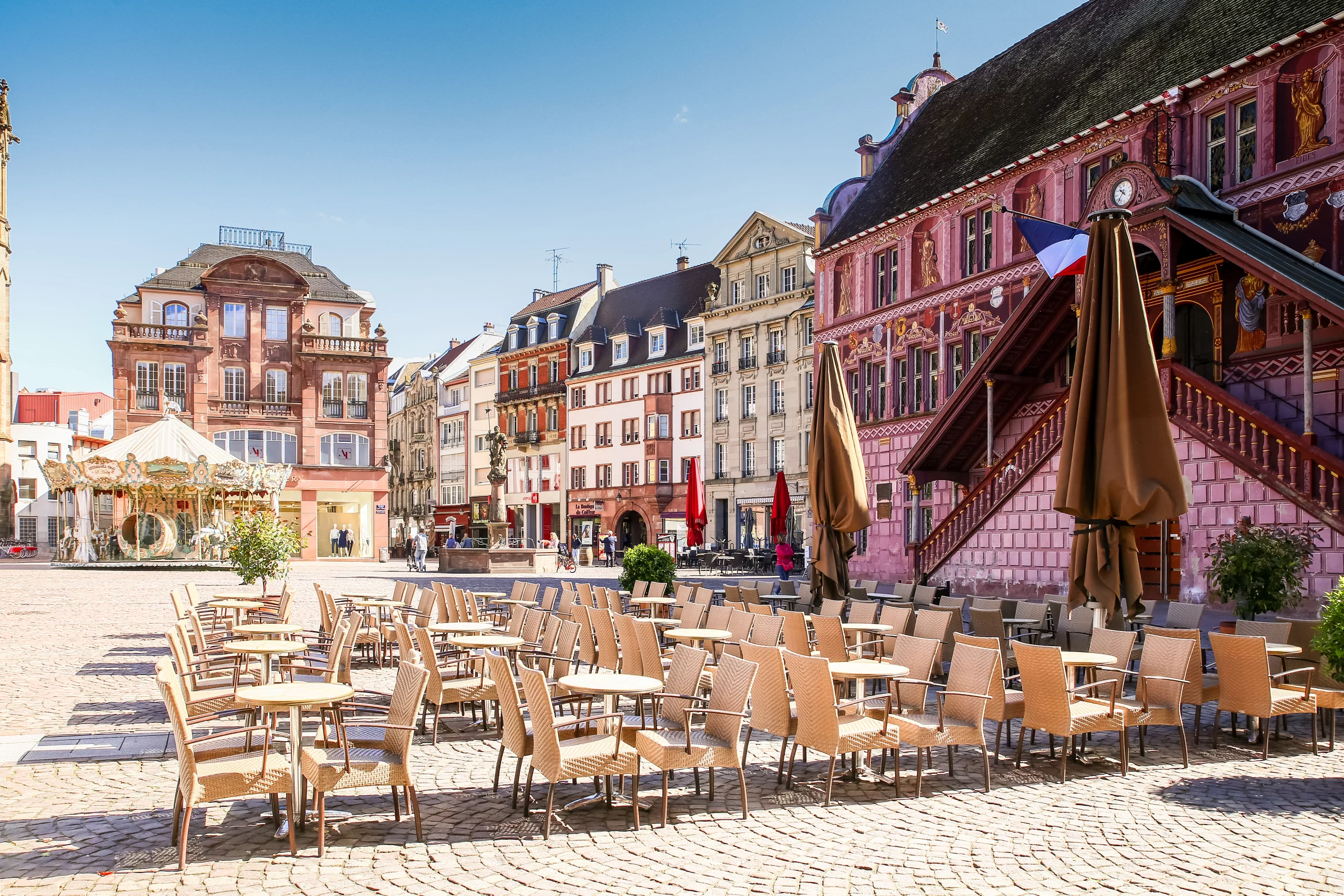 Place vide avec bâtiment historique et carrousel à Mulhouse